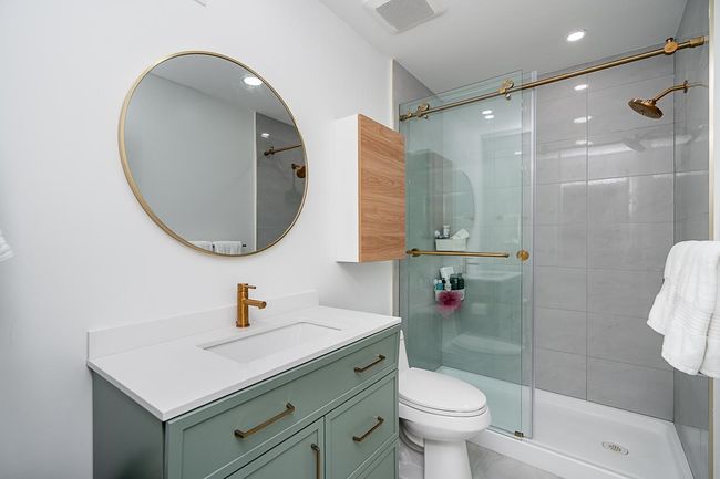 Full bathroom featuring vanity, recessed lighting, toilet, a shower stall, and visible vents | Image 19