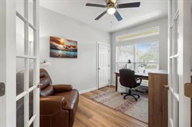Office space with wood finished floors, baseboards, french doors, and ceiling fan | Image 18