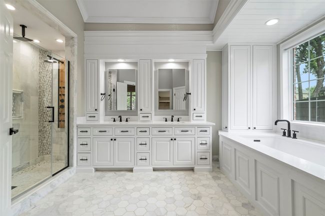 Full bath with double vanity, a shower stall, and crown molding | Image 6