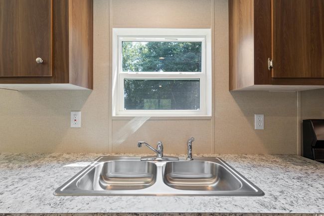 Kitchen featuring light countertops, tasteful backsplash, and dark brown cabinets | Image 13