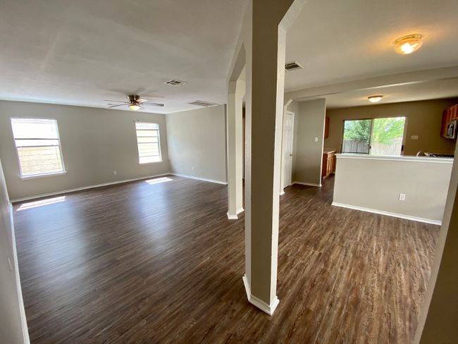 Spare room featuring dark wood finished floors and a ceiling fan | Image 11