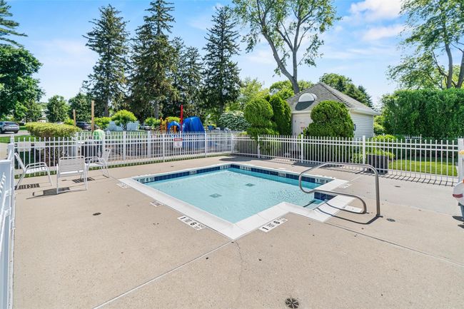 Community pool with a patio area | Image 39