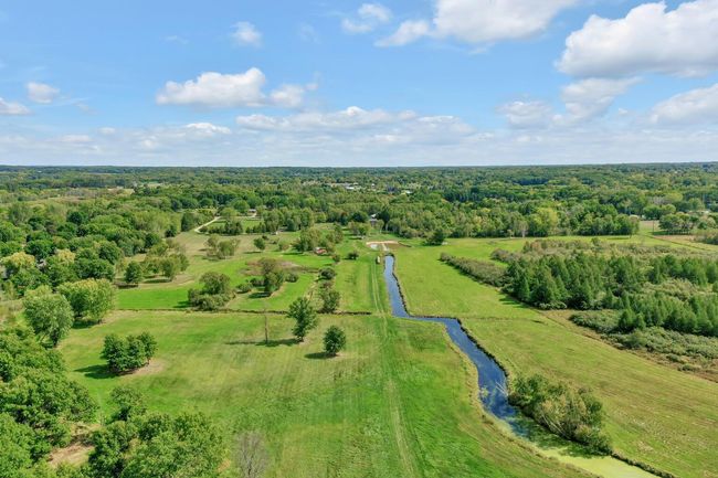 West end of the property facing east, drainage canal in middle of property running east and west. | Image 8