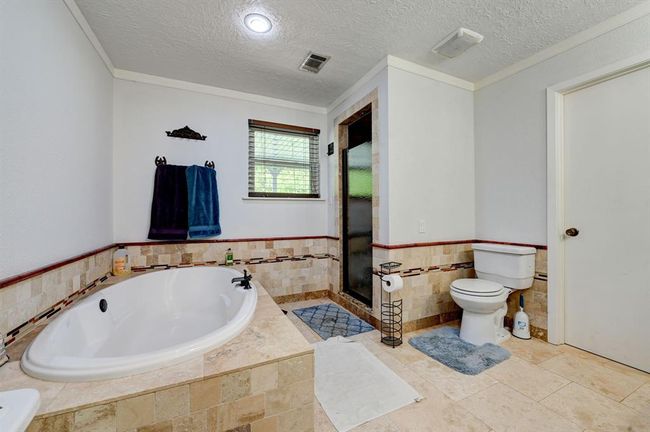 Primary bathroom with separate tub and shower and large closet. | Image 17