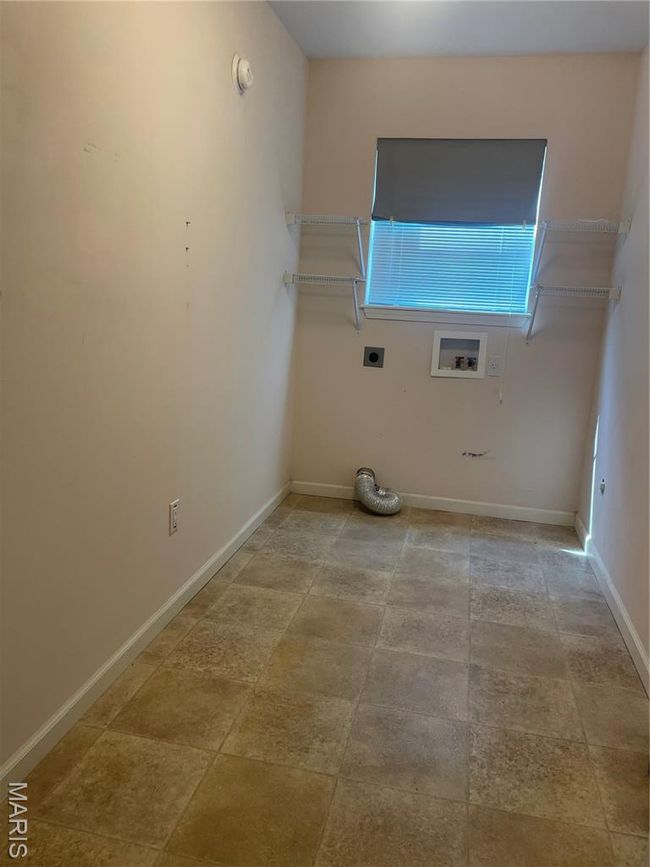 Washroom featuring hookup for a washing machine, electric dryer hookup, and baseboards | Image 18