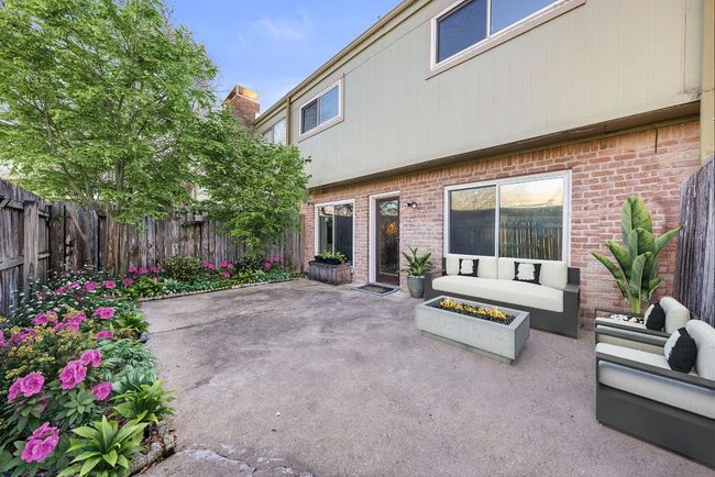 Virtually staged patio featuring an outdoor living space with a fire pit and a fenced backyard | Image 34