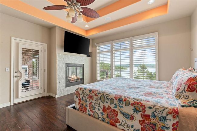 Bedroom with recessed lighting, access to outside, baseboards, a raised ceiling, and dark wood-type flooring | Image 27