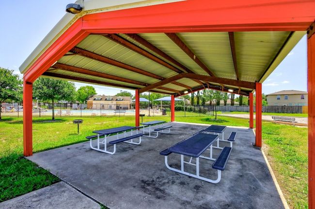 View of property's community featuring fence, a lawn, and a patio | Image 38
