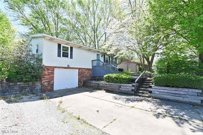 View of side of home with a garage | Image 2