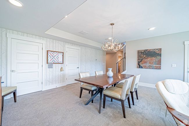 Dining area with light colored carpet, a chandelier, baseboards, and recessed lighting | Image 19