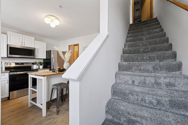 Stairway off the kitchen leads to the upper level | Image 11