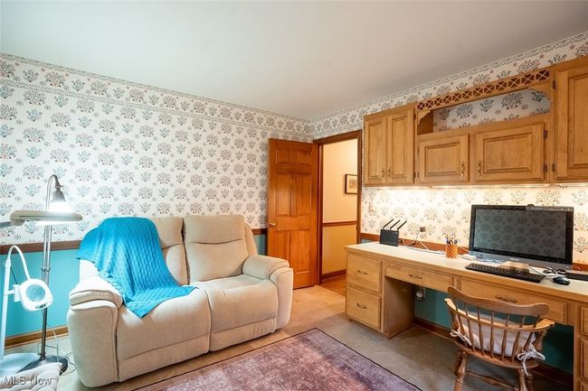 Office area featuring built in study area and wallpapered walls | Image 14