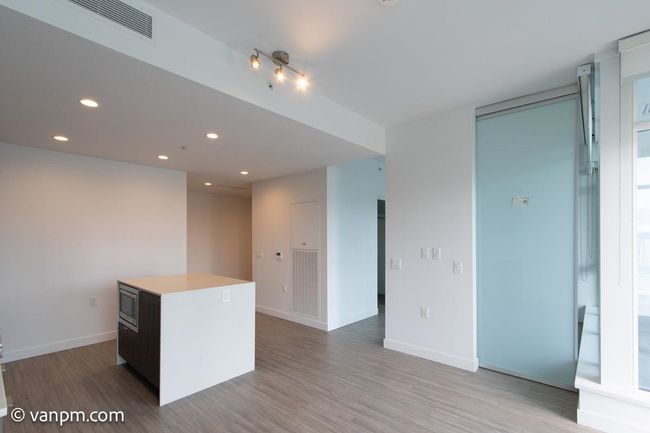 Unfurnished room with light wood finished floors, recessed lighting, and baseboards | Image 9