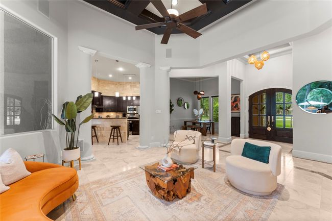 The den flows seamlessly into the dining area and kitchen, creating a connected space ideal for effortless entertaining and everyday interaction. | Image 16