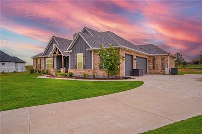 Craftsman inspired home with a garage and a yard | Image 1