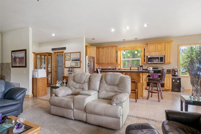 Living room with light tile patterned floors, healthy amount of natural light, and recessed lighting | Image 36