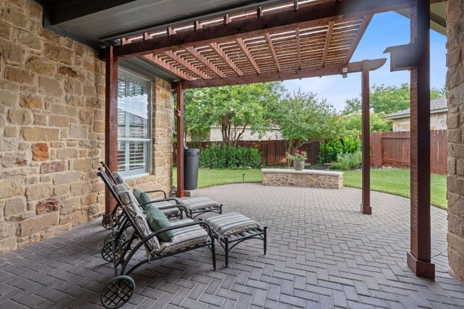 Fenced backyard with a pergola and a patio area | Image 21