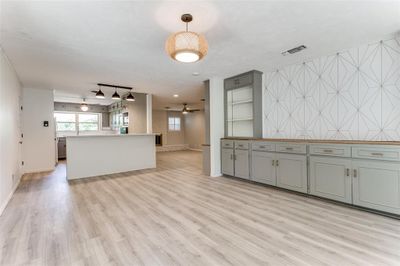 Unfurnished living room featuring ceiling fan, light wood-type flooring, and rail lighting | Image 1