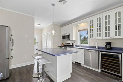 Plenty of cabinets in this open concept kitchen with center island. | Image 3