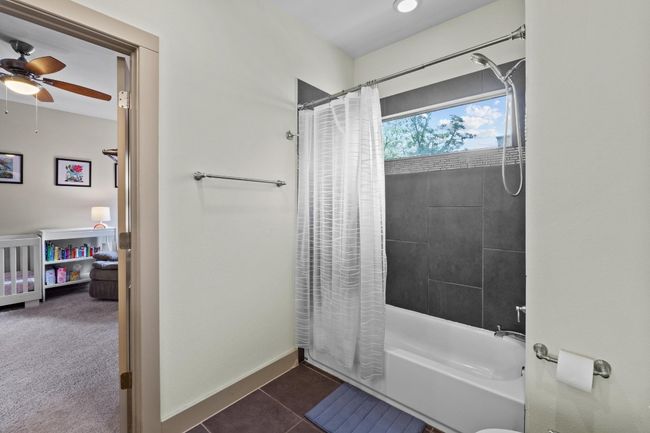 Bathroom with shower / bath combo, baseboards, a ceiling fan, and tile patterned flooring | Image 21