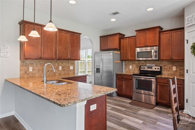 Fully equipped kitchen with eating bar. | Image 11