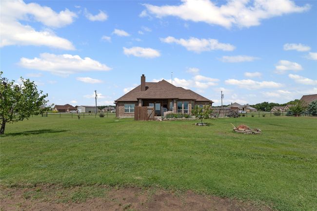 Rear view of property featuring a chimney and brick siding | Image 20