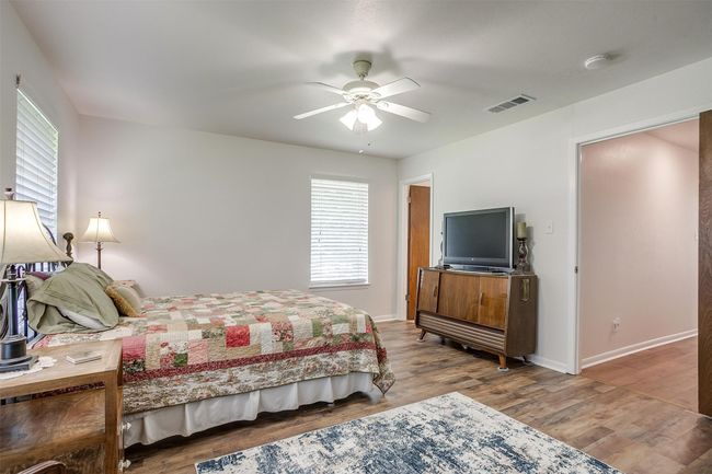Bedroom with wood finished floors and a ceiling fan | Image 24