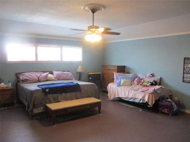 Bedroom with carpet and ceiling fan | Image 31