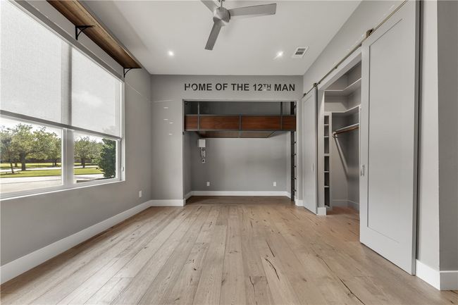 Unfurnished bedroom with light wood-style floors, recessed lighting, and a ceiling fan | Image 16