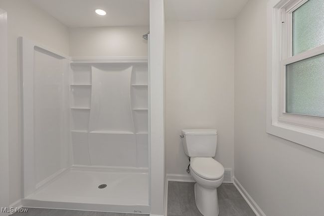 Bathroom featuring hardwood / wood-style floors, toilet, and walk in shower | Image 27