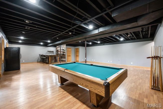 Playroom with bar, billiards, wood finished floors, and baseboards | Image 35