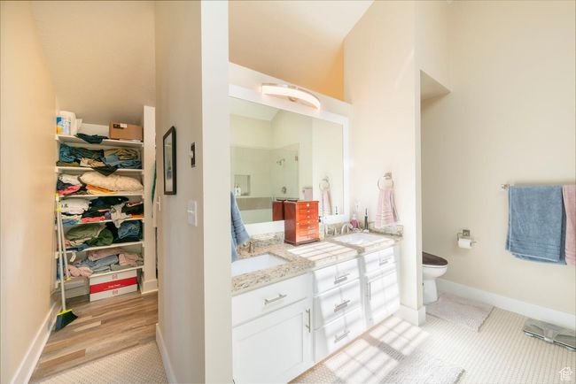 Bathroom with a sink, toilet, double vanity, and a stall shower | Image 30