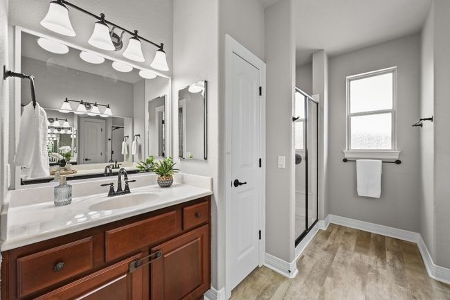 Bathroom with wood-like finished floors, a stall shower, and vanity | Image 19