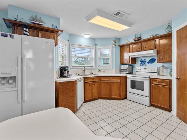 Kitchen has views out to the back deck and canal. | Image 10