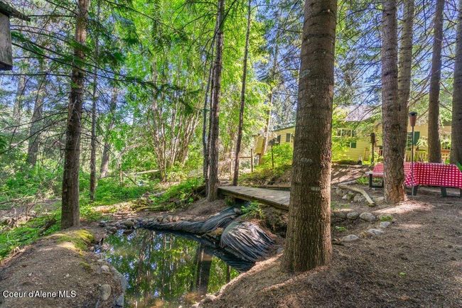 Oasis and Zen area adjoining the front of the house with a small pond | Image 33
