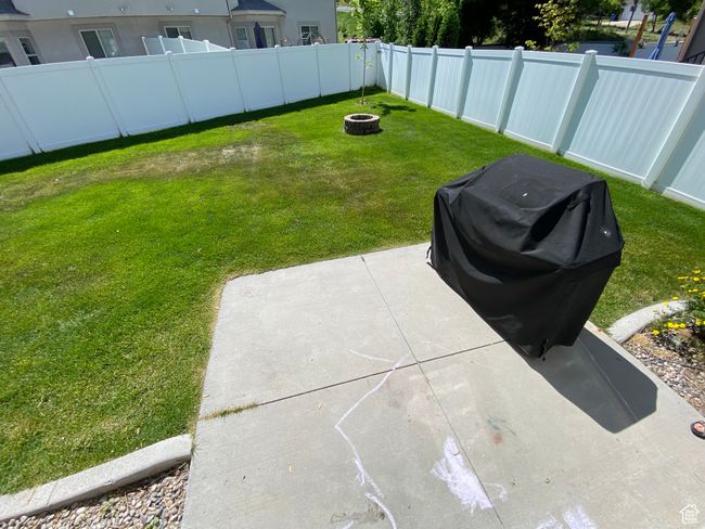 View of yard with a fire pit and a patio | Image 24