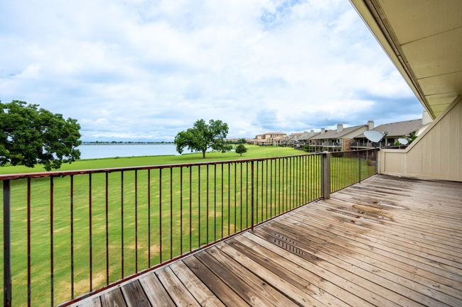 Deck with a water view and a yard | Image 5