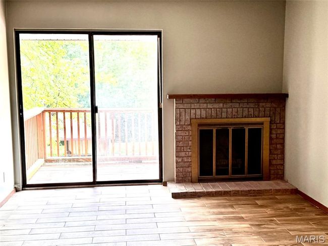 Unfurnished living room featuring plenty of natural light and wood finished floors | Image 11