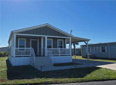 Welcome to your new home in Tamiami Village! Relax on your front porch and watch the world go by! | Image 1