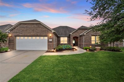 Captivating Showplace located in the vibrant 55+ community of Del Web\ Sweetgrass in Richmond TX. Walking distance to the Club House where so much of the "action" takes place. Attraction Elevation and Brick welcome you along with the landscaping and beautiful grass. | Image 1