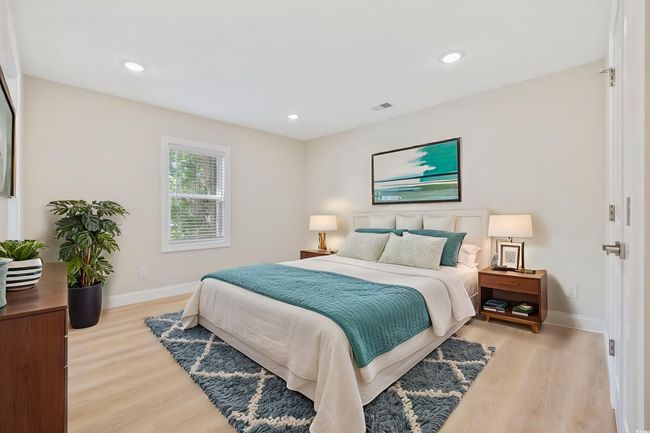 Bedroom featuring light wood finished floors, baseboards, and recessed lighting | Image 14