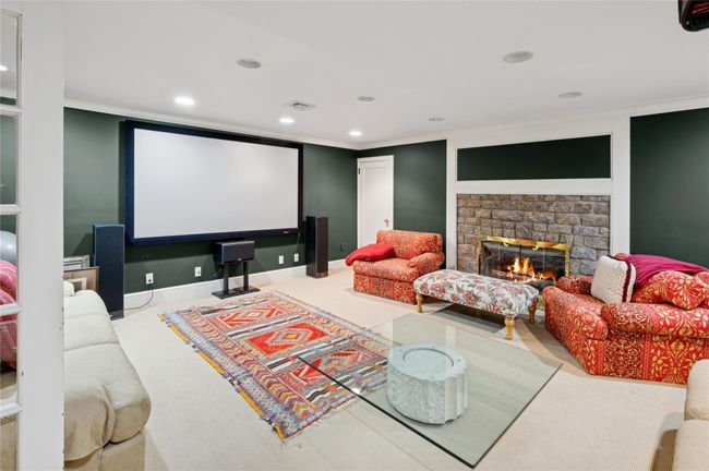Home theater room featuring recessed lighting, a fireplace, and crown molding | Image 34