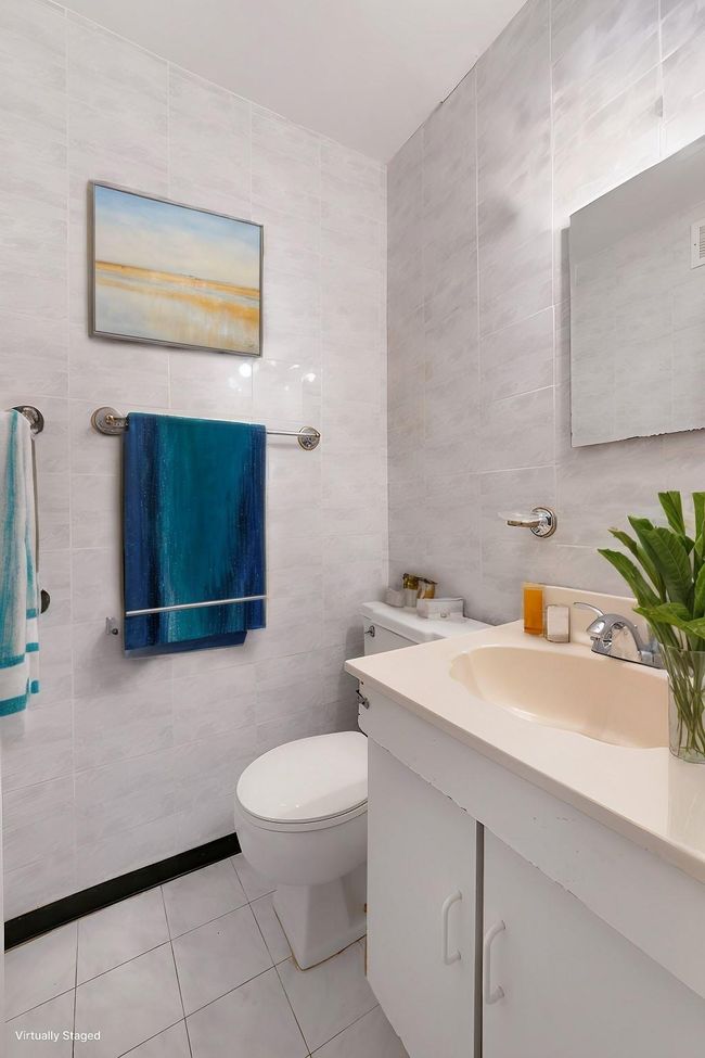 Bathroom featuring tile walls, vanity, toilet, and tile patterned floors | Image 10