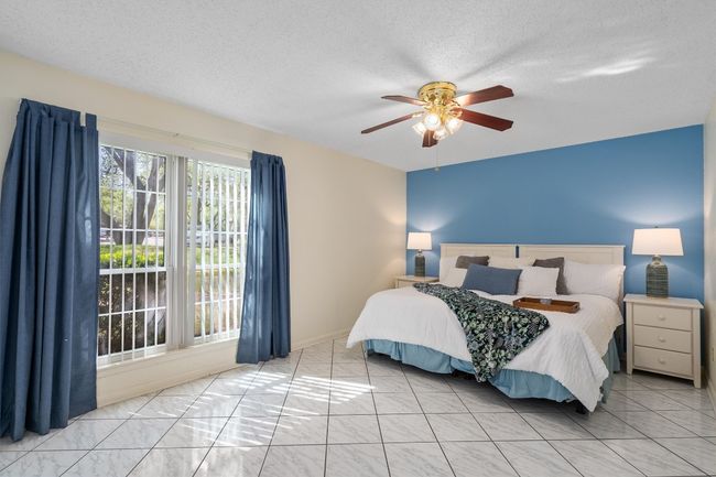Bedroom with a textured ceiling and a ceiling fan | Image 19