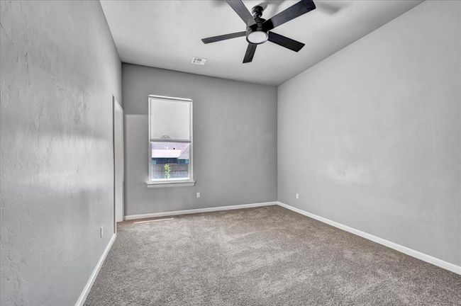 Unfurnished room with carpet, ceiling fan, and baseboards | Image 41