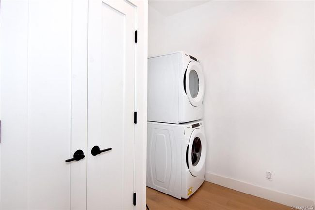 In-unit laundry with custom shelving and a large closet for storage. | Image 15