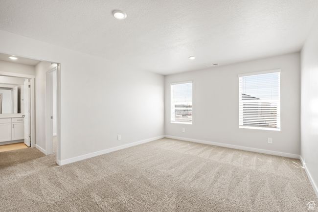 Empty room with light colored carpet, baseboards, and recessed lighting | Image 28