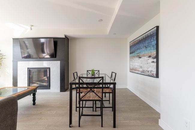 Kitchen featuring tasteful backsplash, modern cabinets, stainless steel appliances, light wood-style flooring, and gray cabinetry | Image 8