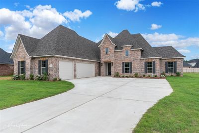 View of front of home featuring a garage and a front lawn | Image 1