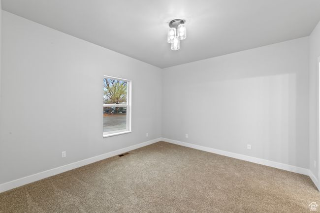 Carpeted spare room with baseboards and visible vents | Image 22